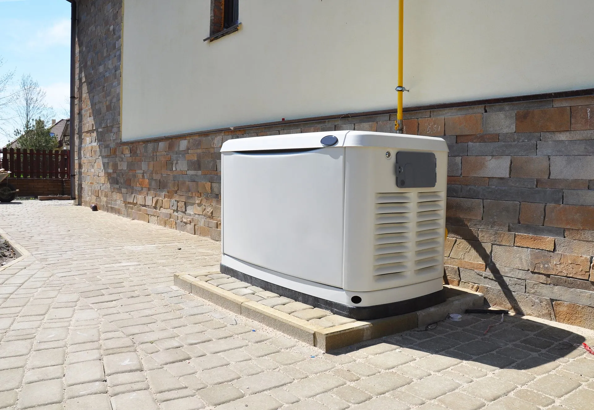 Residential standby generator installed beside a home